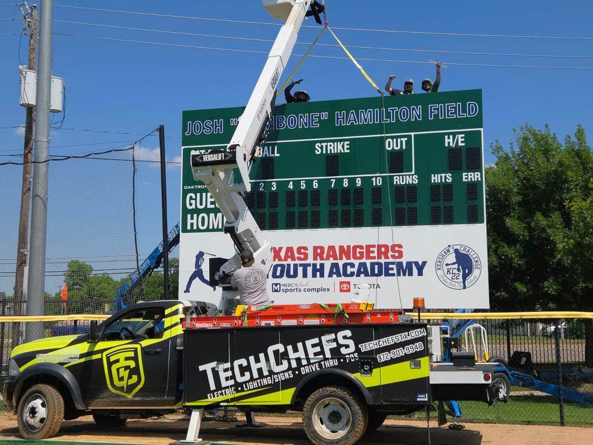 Crew on top of the Rangers Academy scoreboard