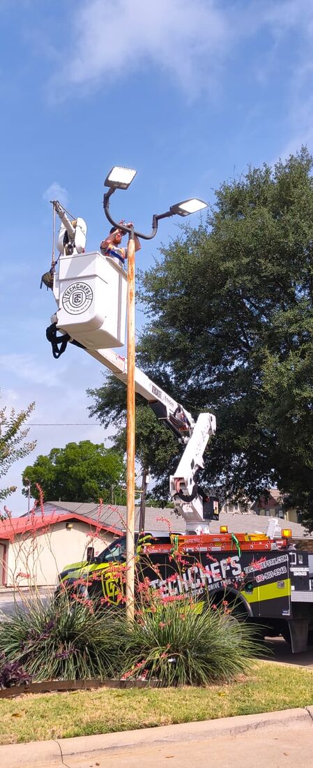Parking lot light repair by bucket truck